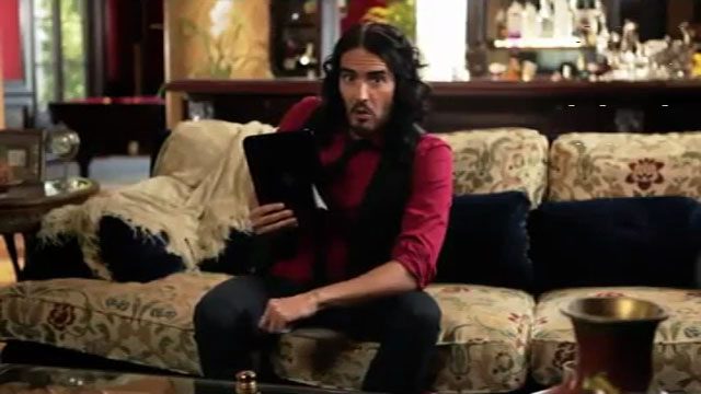 Russell Brand holding an HP Touchpad