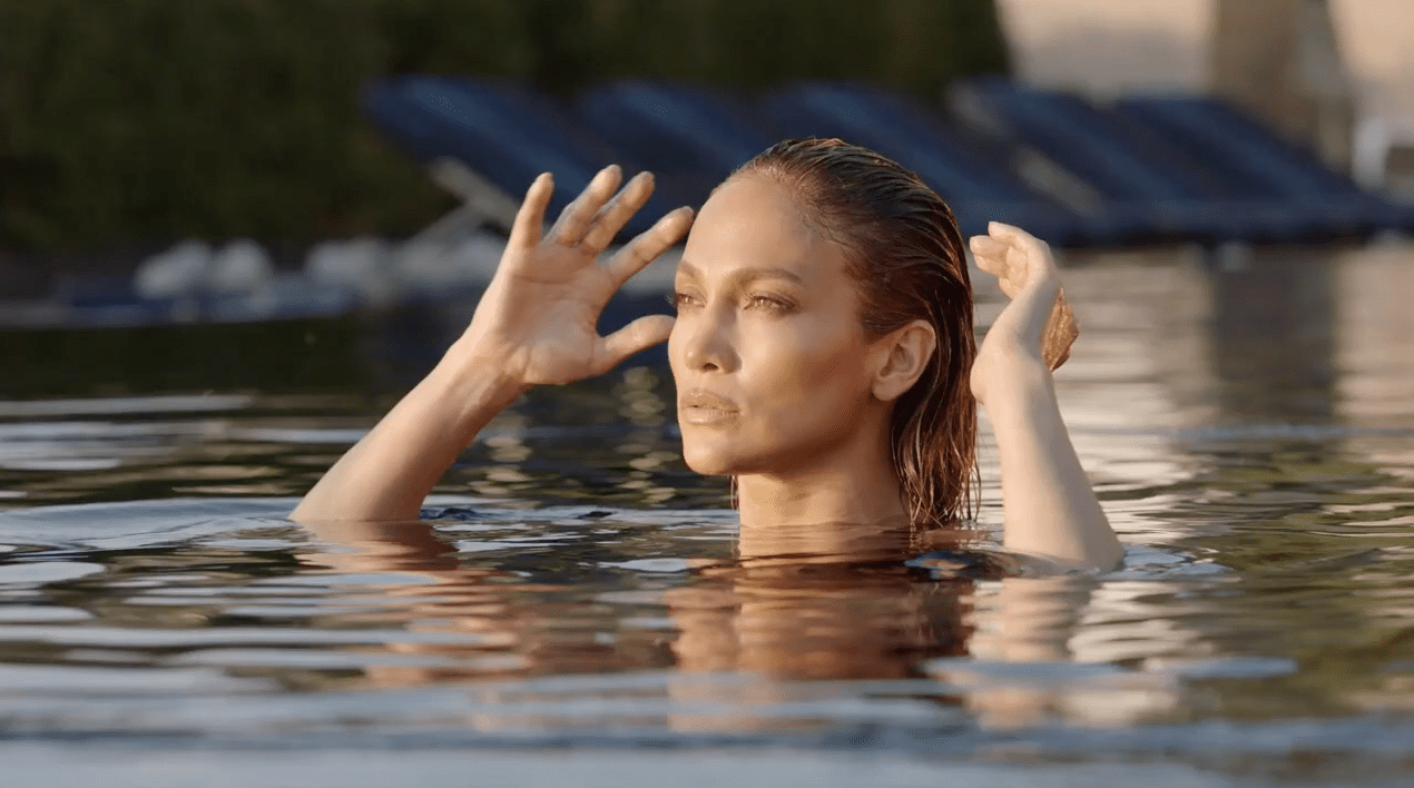 Jennifer Lopez in pool looking at the sun