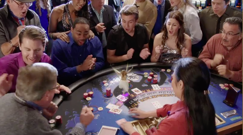 group celebrates at poker table. Play Lady Luck Commercial.
