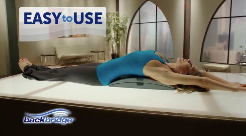 woman lays on backbridge stretching.