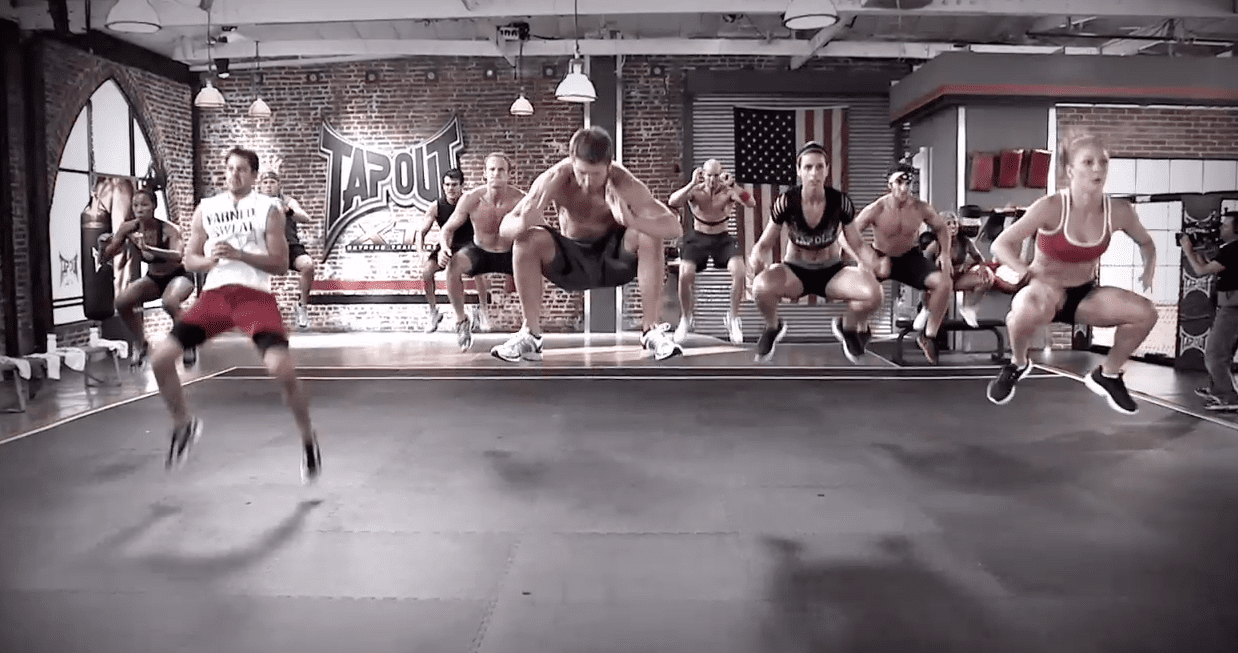 Fitness team jumping in Tapout workout video