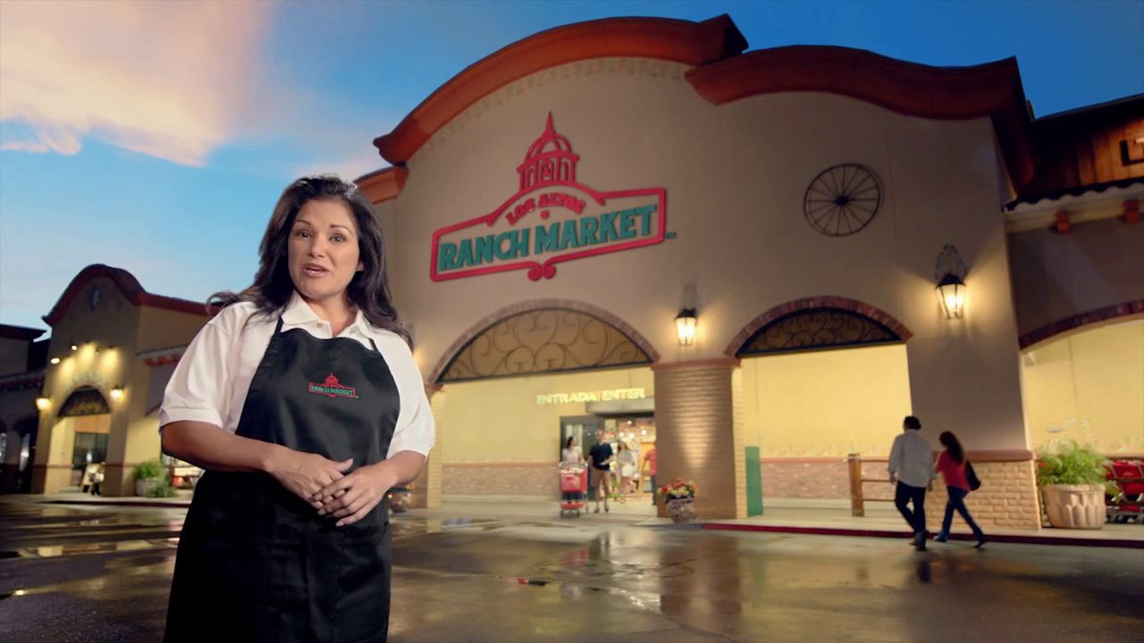 Latino woman in frot of Los Altos Ranch Market. Play commercial