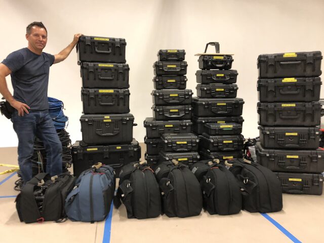 man with a stack of cases